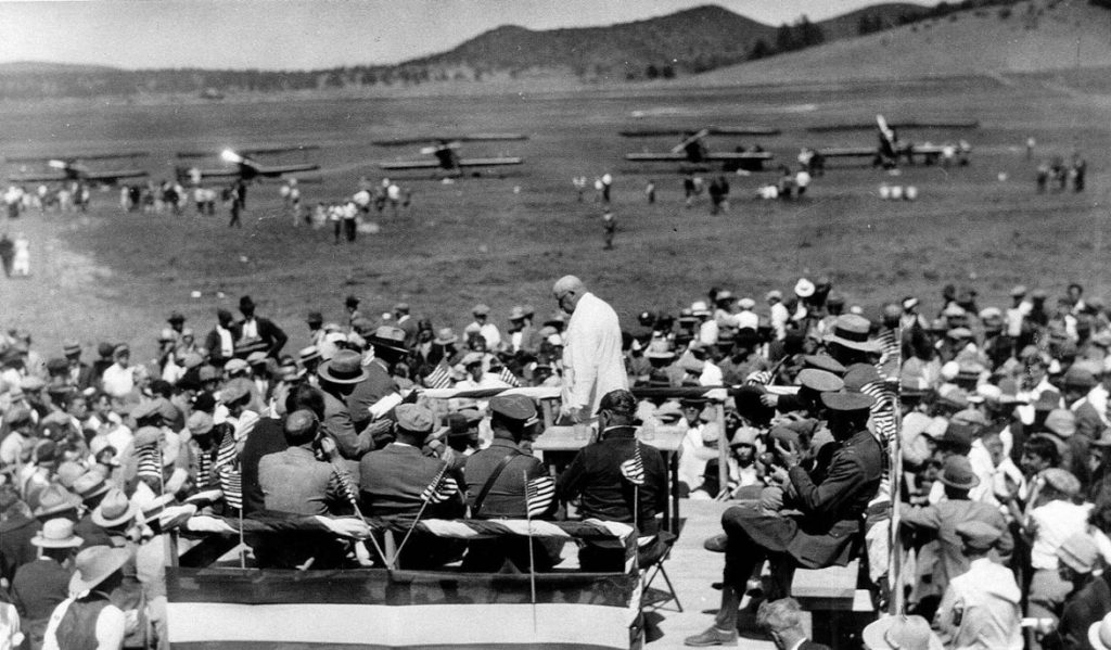 Vintage photo showing gathering of people and airplanes at Flagstaff Airport